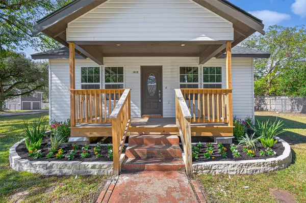 a front view of a house with garden