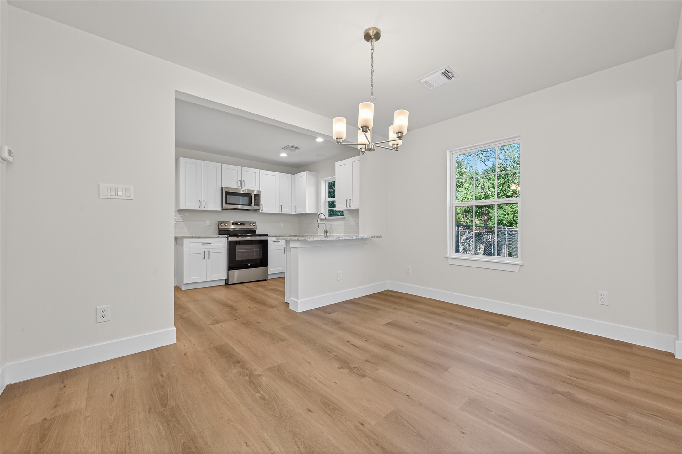 1418 Carlisle Street Rosenberg, TX 77471 - Photo 32 of 49 a view of a kitchen with a sink a cabinet and wooden floor