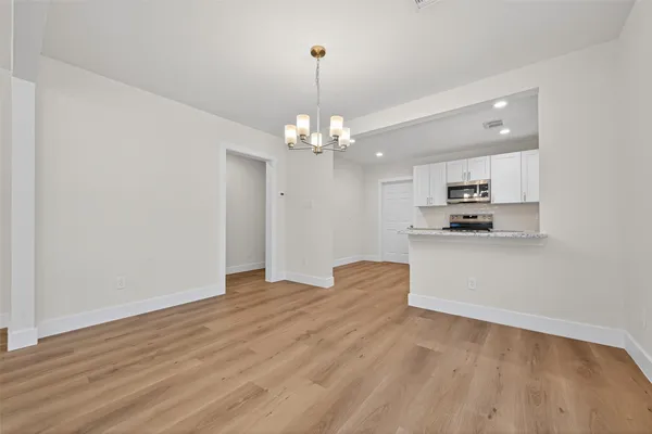 a view of a kitchen with microwave and cabinets