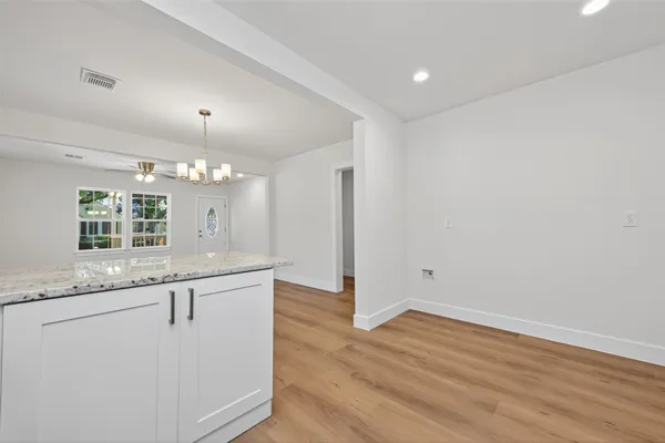 a view of a kitchen with granite countertop cabinets and wooden floor