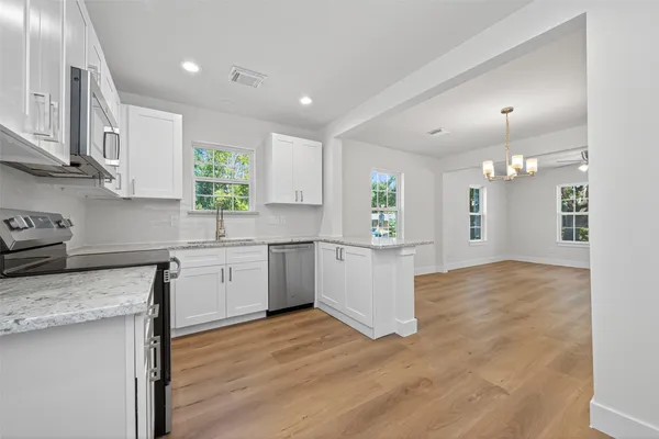 a kitchen with a sink cabinets and window