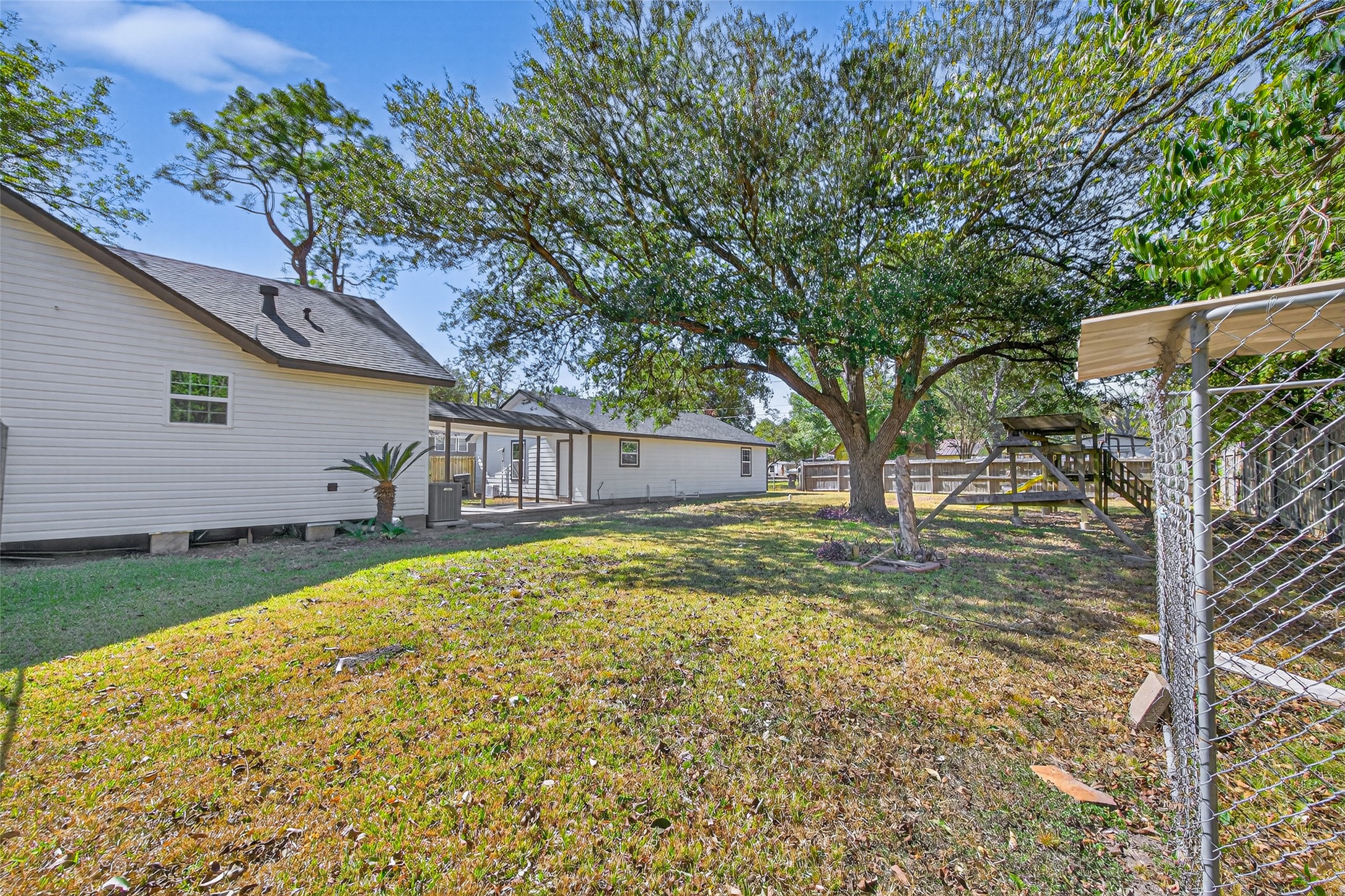 1418 Carlisle Street Rosenberg, TX 77471 - Photo 42 of 49 a view of backyard with large trees and potted plants