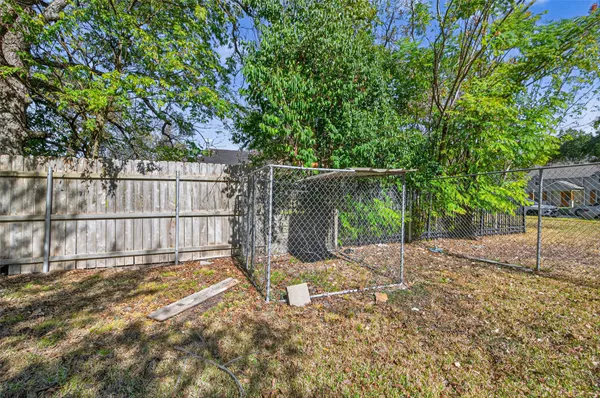 a view of a backyard with wooden fence