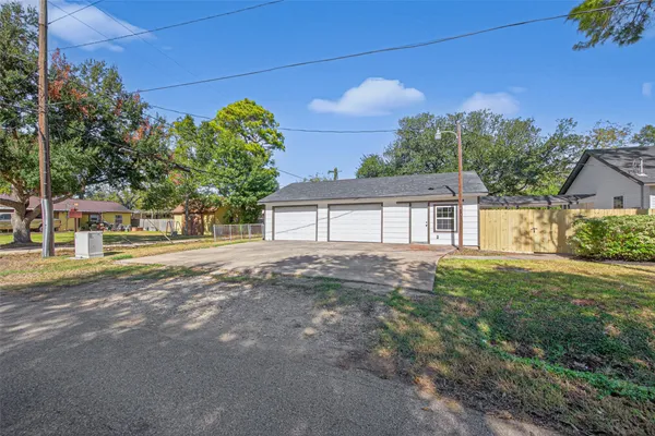 a view of a house with a yard and a garage