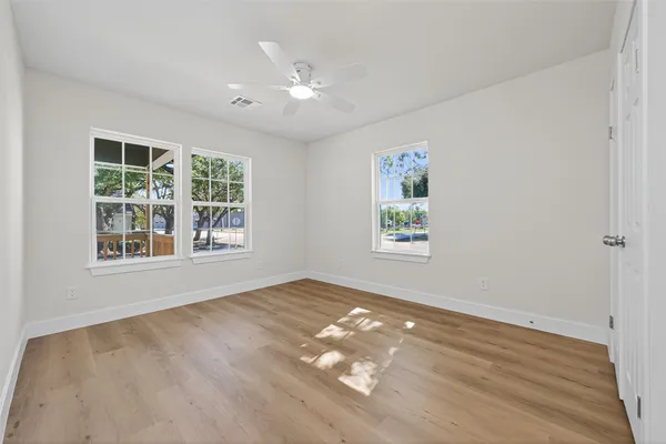 wooden floor in an empty room with a window