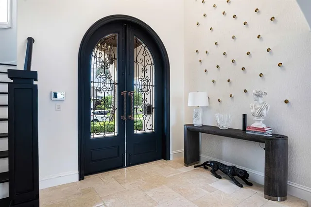 a bedroom with a large bed and a chandelier
