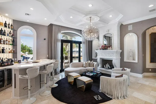 a living room with furniture and a chandelier