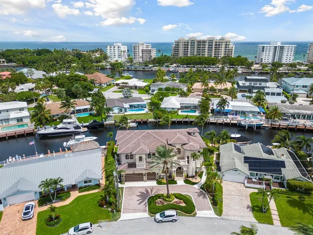 a living room with furniture a fireplace and a chandelier