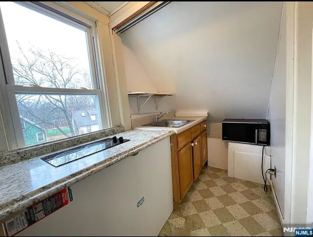a kitchen with a sink stove and cabinets