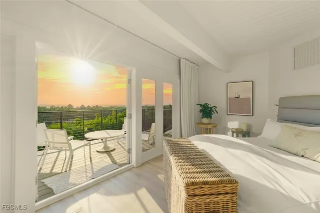 a bedroom with a bed and a view of balcony