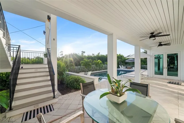 a view of a patio with a dining table and chairs