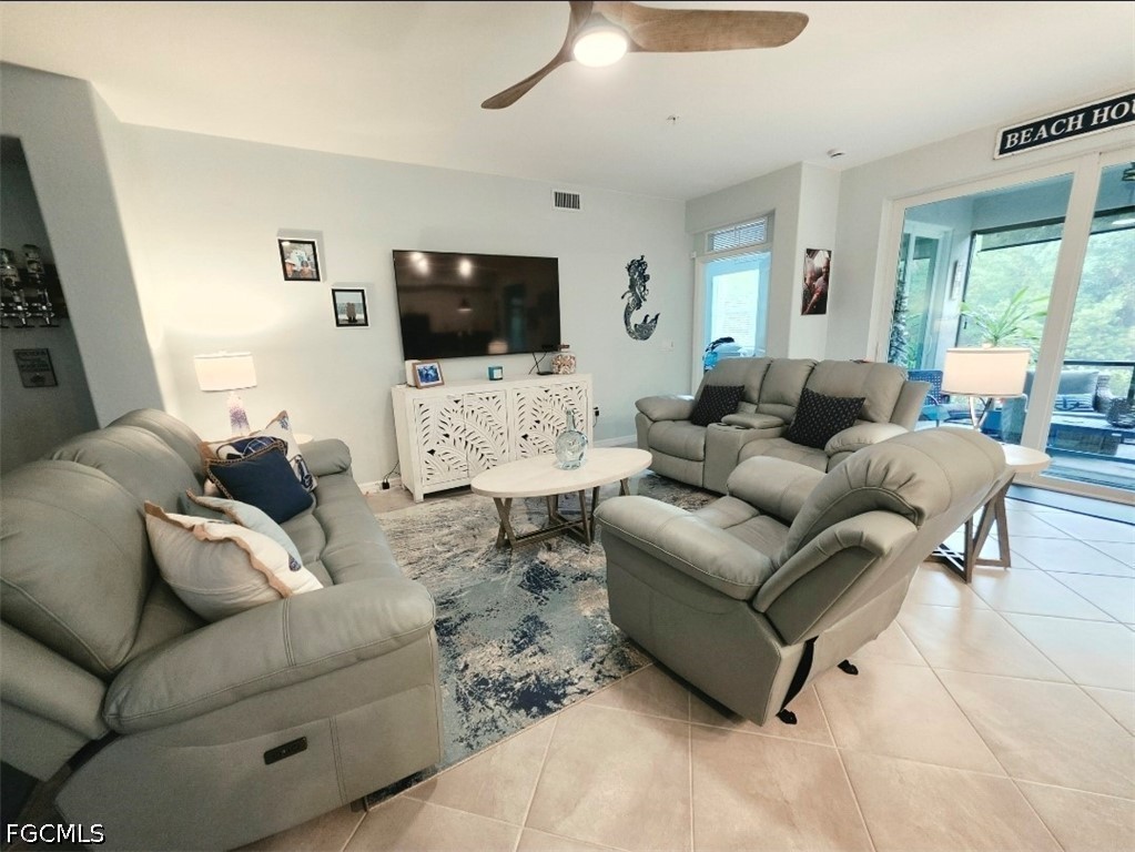 14191 Poppy Fld Loop, Unit 5312 Punta Gorda, FL 33955 - Photo 12 of 41 a living room with furniture a flat screen tv and a large window