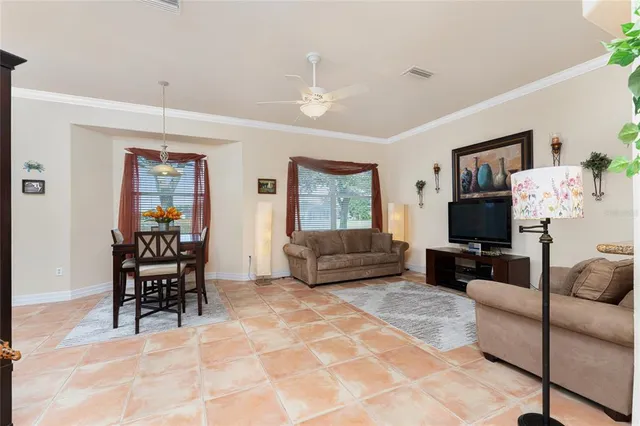 a view of a dining room with furniture and a potted plant