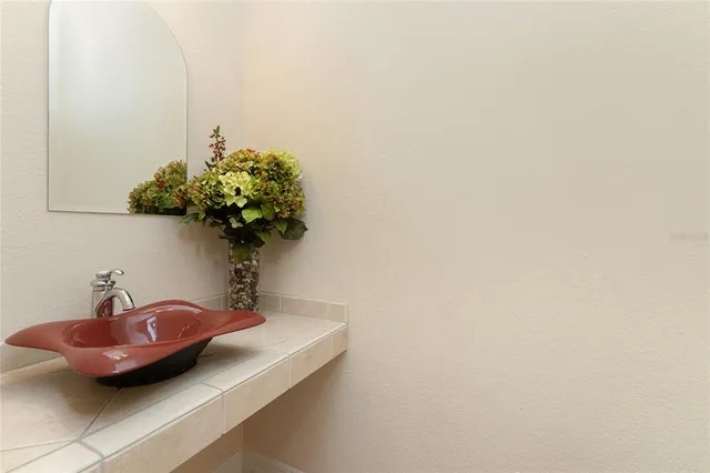 a bathroom with a sink a toilet and a mirror