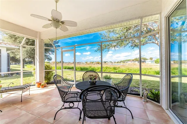 a view of a swimming pool with a chairs and table in the patio