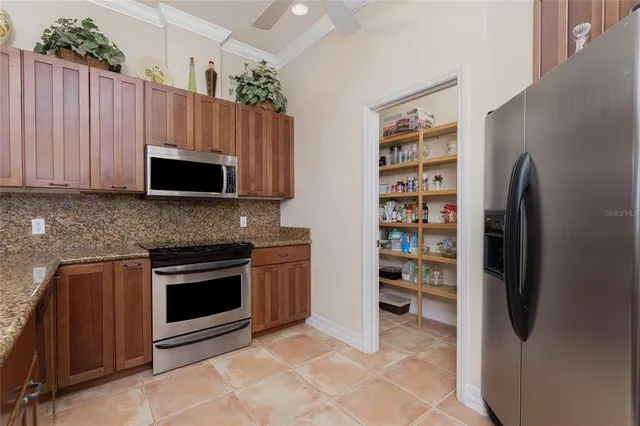 a kitchen with stainless steel appliances granite countertop a sink stove and microwave