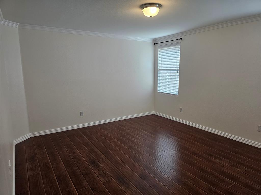 3009 Meadow Bluff Drive Wylie, TX 75098 - Photo 12 of 24 an empty room with wooden floor and windows