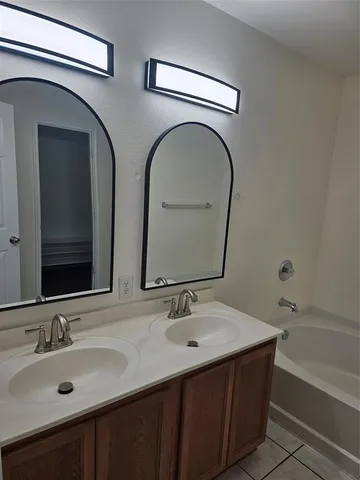 a bathroom with 2 sink and a bathtub