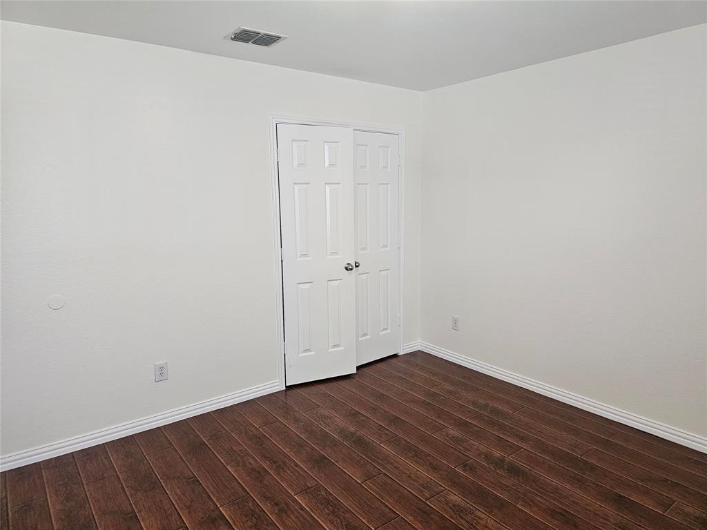 3009 Meadow Bluff Drive Wylie, TX 75098 - Photo 20 of 24 a view of an empty room with wooden floor