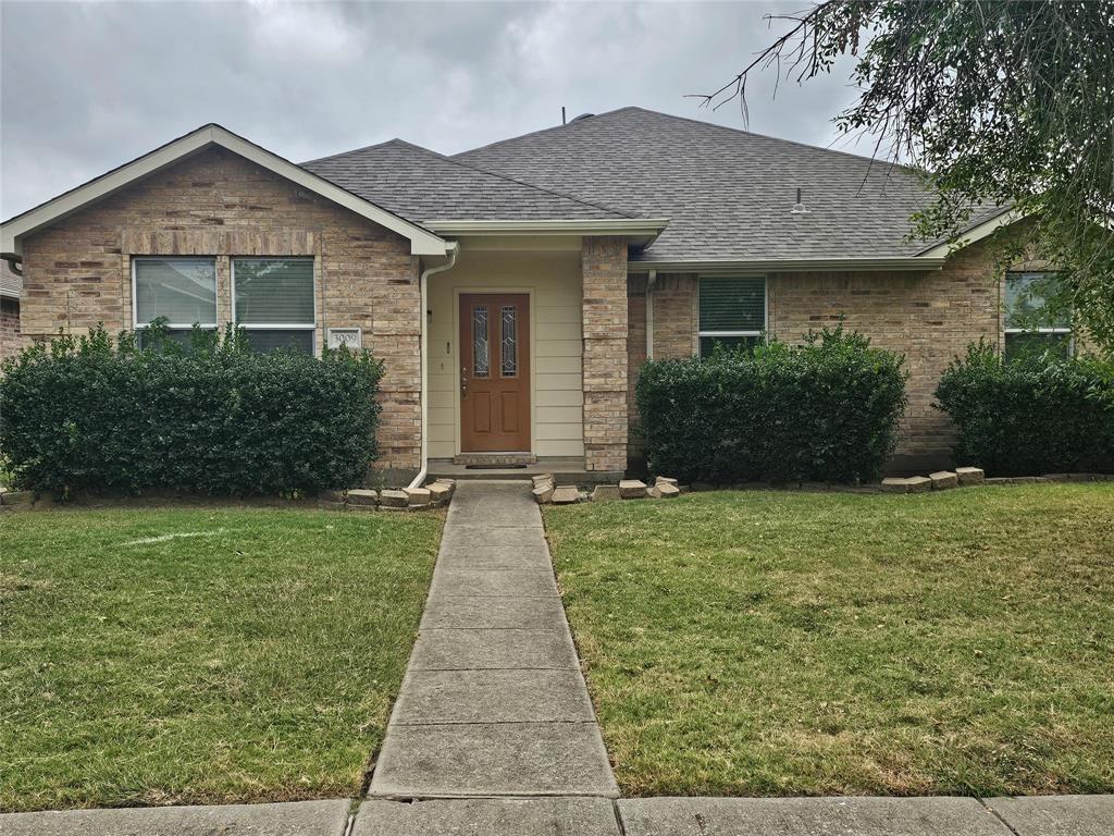 3009 Meadow Bluff Drive Wylie, TX 75098 - Photo 2 of 24 a front view of a house with a yard