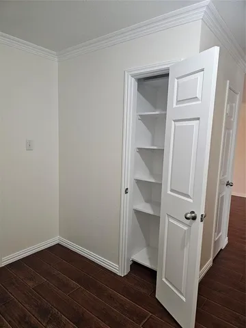 an empty room with wooden floor