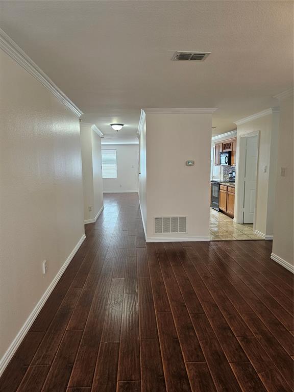 3009 Meadow Bluff Drive Wylie, TX 75098 - Photo 3 of 24 a view of an empty room with wooden floor and a window