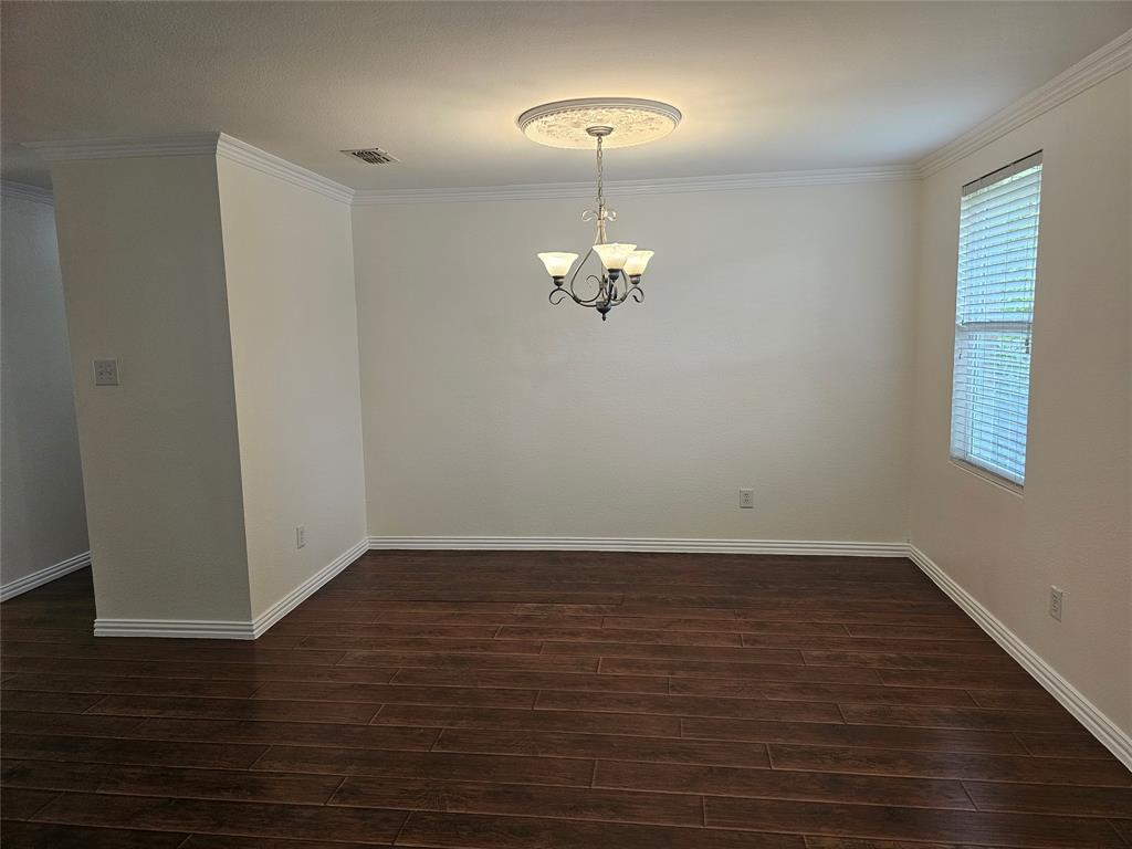 3009 Meadow Bluff Drive Wylie, TX 75098 - Photo 4 of 24 a view of an empty room with wooden floor and a chandelier