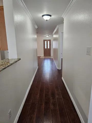 a view of gallery with wooden floor