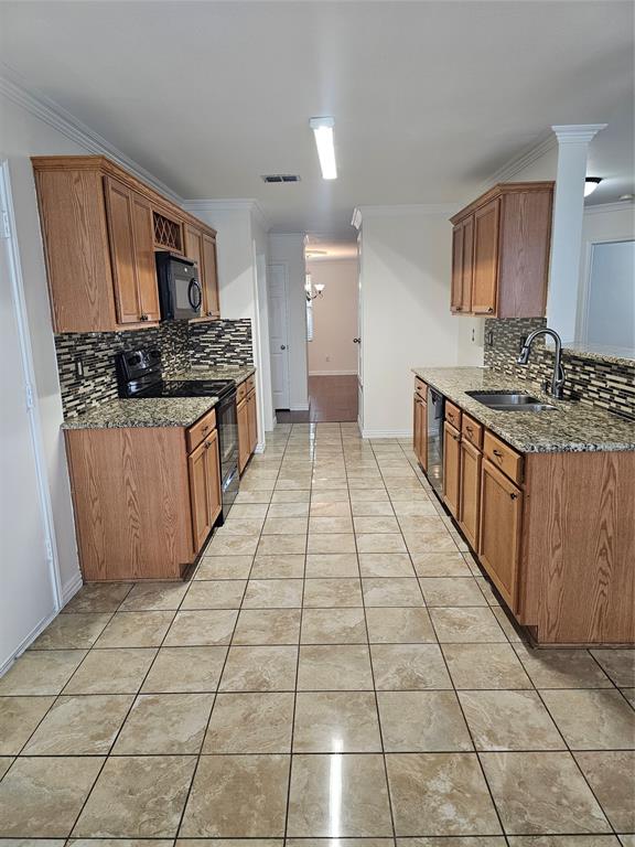 3009 Meadow Bluff Drive Wylie, TX 75098 - Photo 8 of 24 a large kitchen with stainless steel appliances a stove a sink and a refrigerator