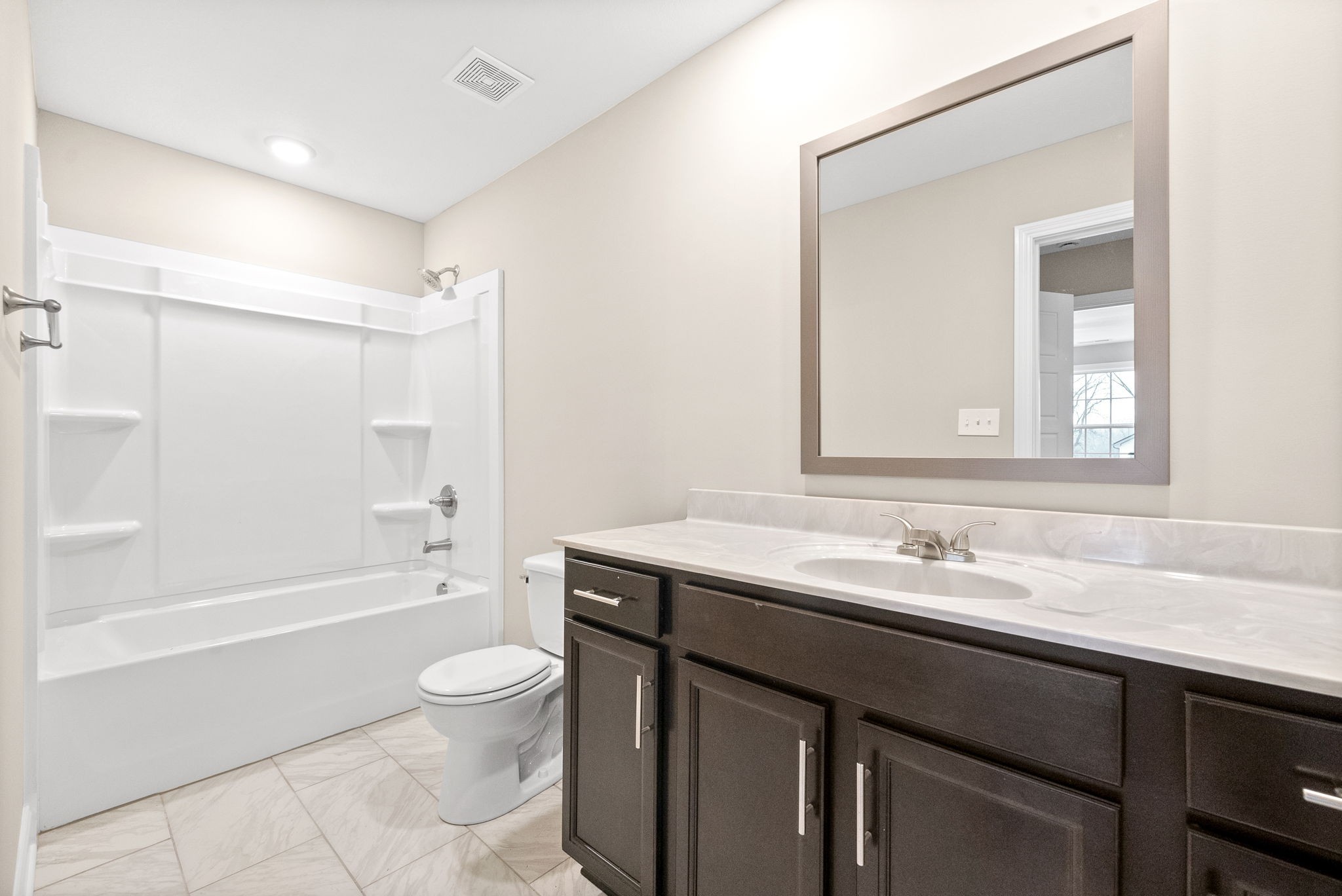 1237 Cardinal Crk Drive Clarksville, TN 37040 - Photo 17 of 26 a bathroom with a granite countertop sink toilet a large mirror a bathtub and shower