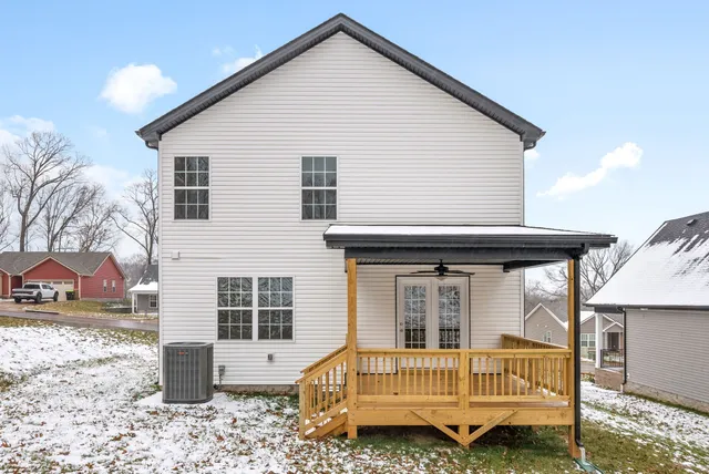 a view of a house with a yard and furniture