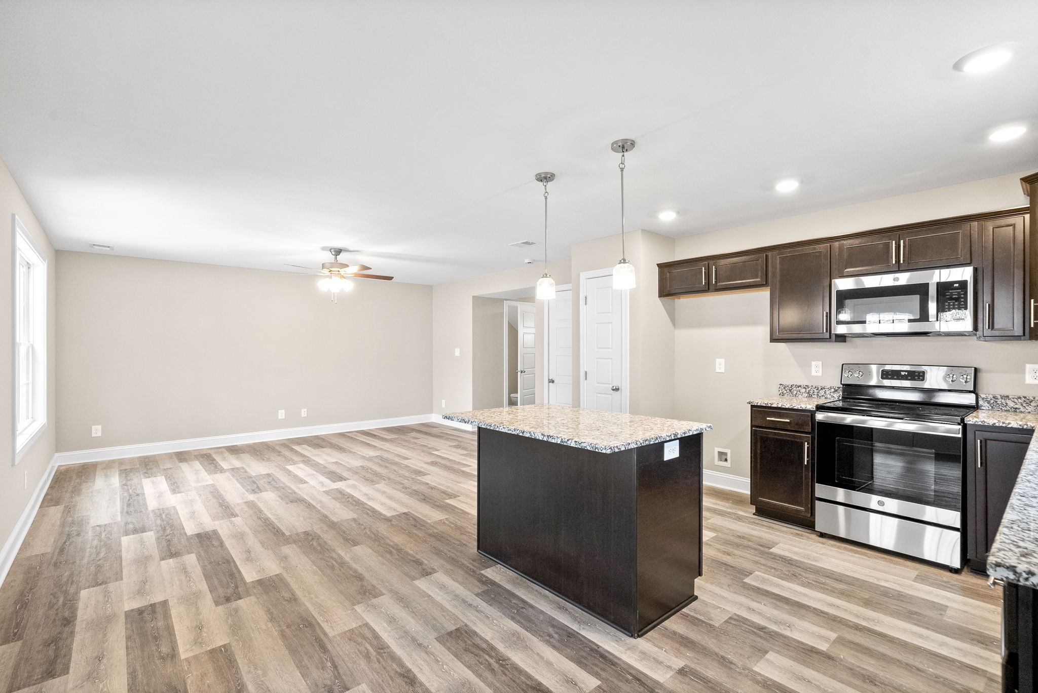 1237 Cardinal Crk Drive Clarksville, TN 37040 - Photo 3 of 26 a kitchen with stainless steel appliances granite countertop a sink a stove and a refrigerator