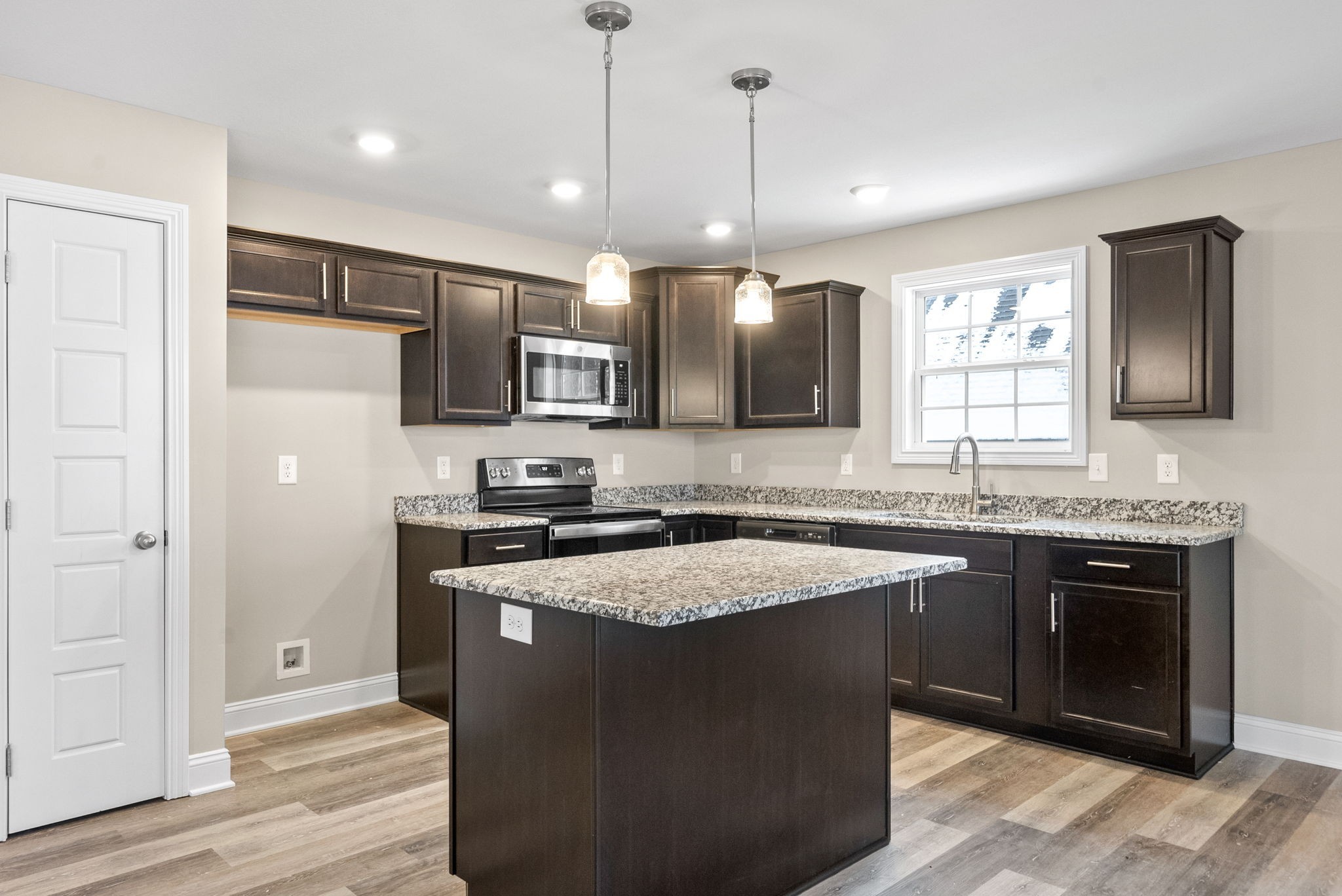 1237 Cardinal Crk Drive Clarksville, TN 37040 - Photo 5 of 26 a kitchen with stainless steel appliances granite countertop a stove a sink and a refrigerator