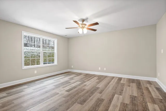 wooden floor in an empty room with a window