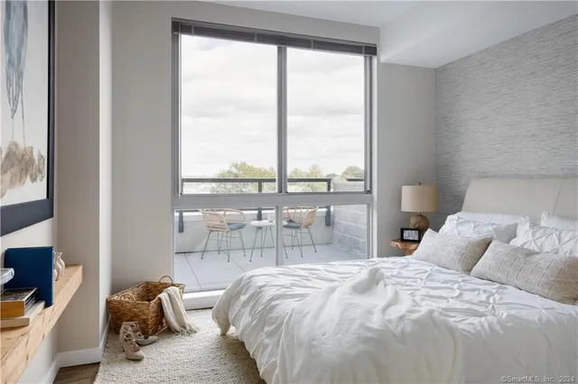 a bedroom with bed and a window