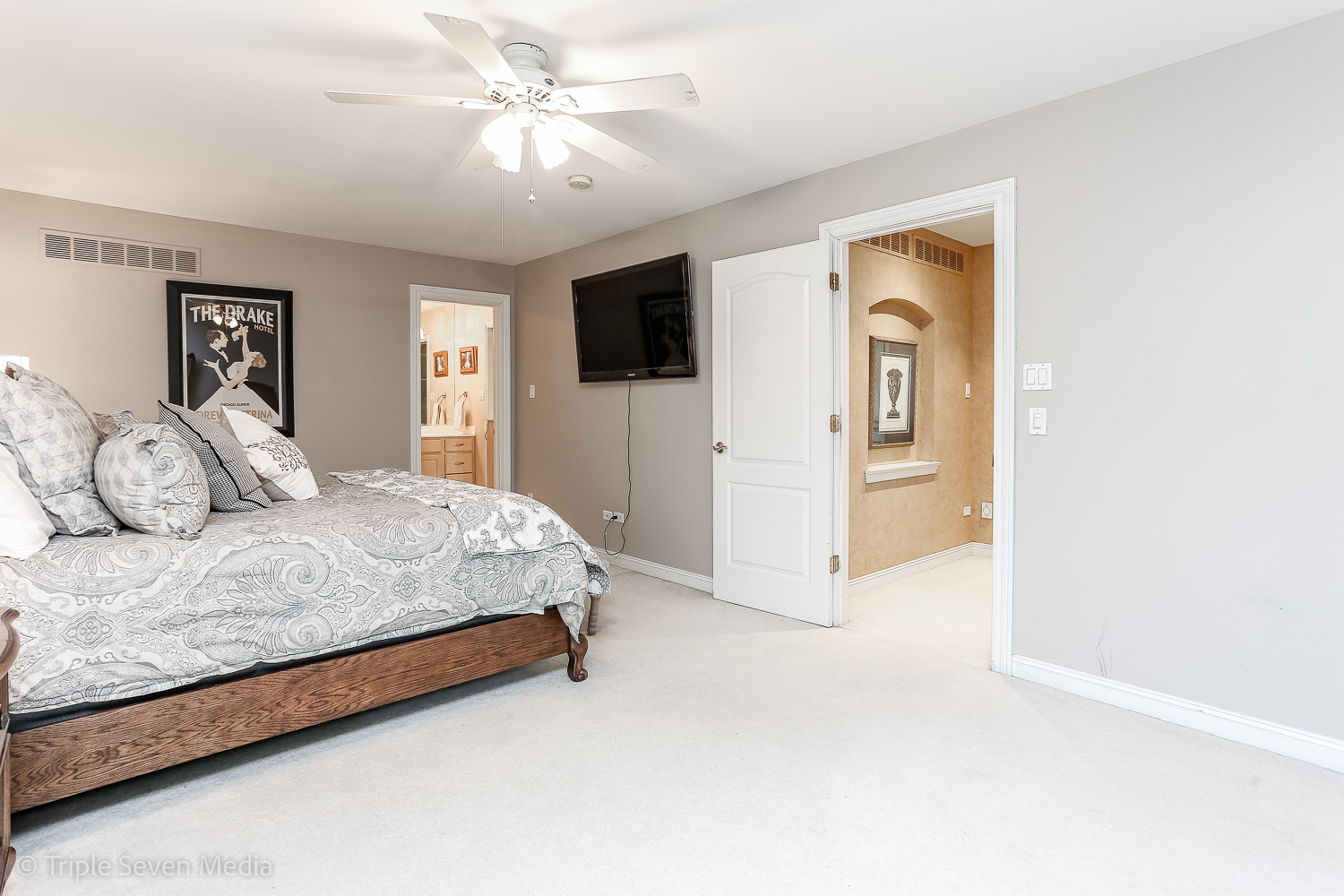 721 Chatfield Road New Lenox, IL 60451 - Photo 54 of 76 a spacious bedroom with a bed and a chandelier