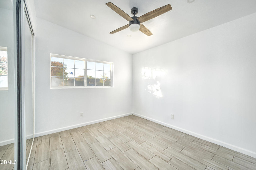 1931 Ukiah Street Oxnard, CA 93035 - Photo 9 of 12 an empty room with wooden floor and windows