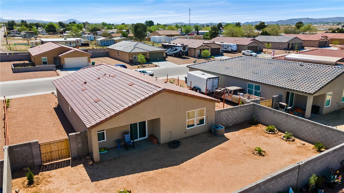 3623 East Andrea Drive Kingman, AZ 86409 - Photo 32 of 40 The property features a tile roof, a private patio, and a fenced yard with desert landscaping