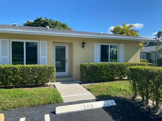 a kitchen with kitchen island a sink and a refrigerator