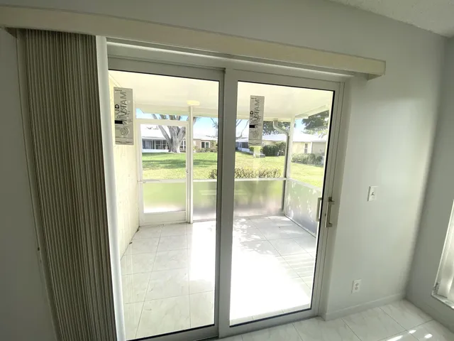 a view of a glass door and a living room