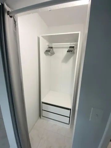 a bathroom with a glass door shower
