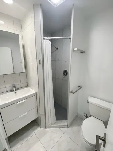 a kitchen with granite countertop a sink a stove and cabinets