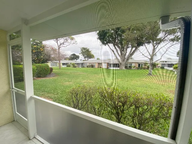 an aerial view of a house with swimming pool patio and outdoor seating
