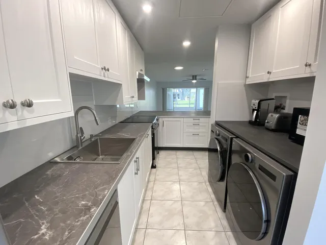 a kitchen with a sink a stove and cabinets