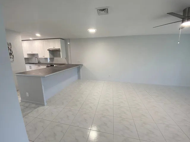 a view of kitchen with sink cabinets and outdoor space