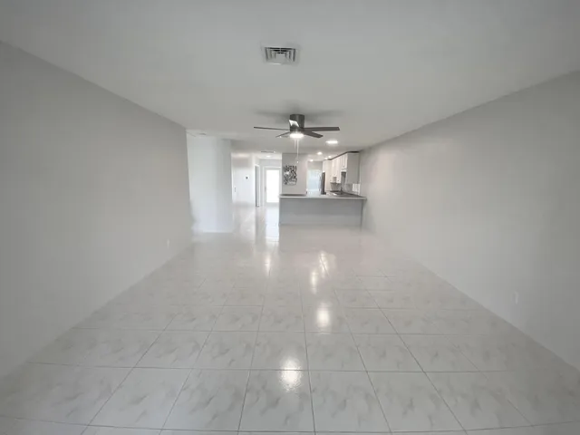 a view of a room with a kitchen