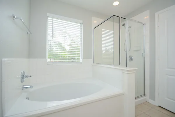 a white bath tub sitting next to a window