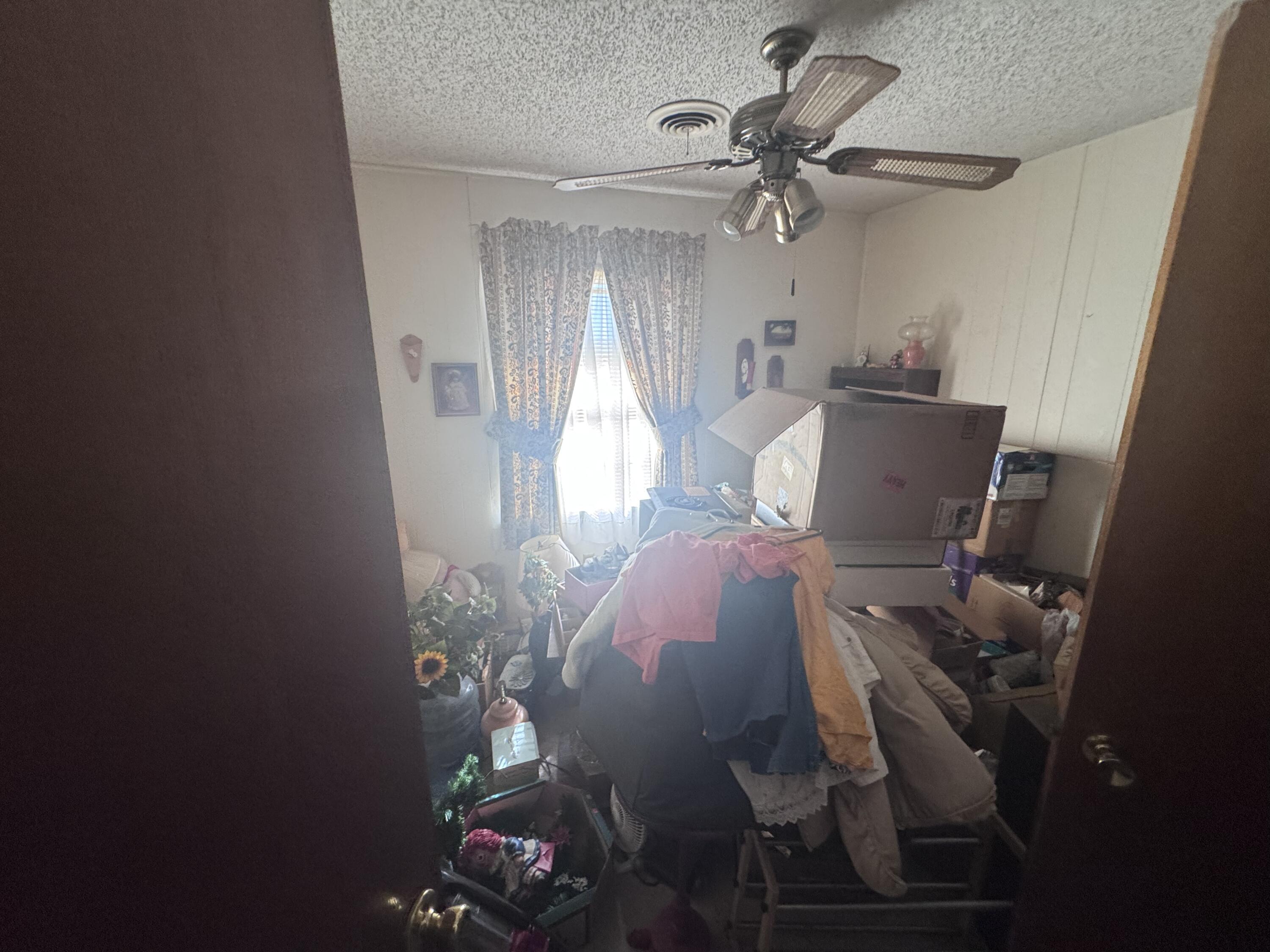 5116 44th Street Lubbock, TX 79414 - Photo 13 of 14 a bedroom with a bed and a chandelier