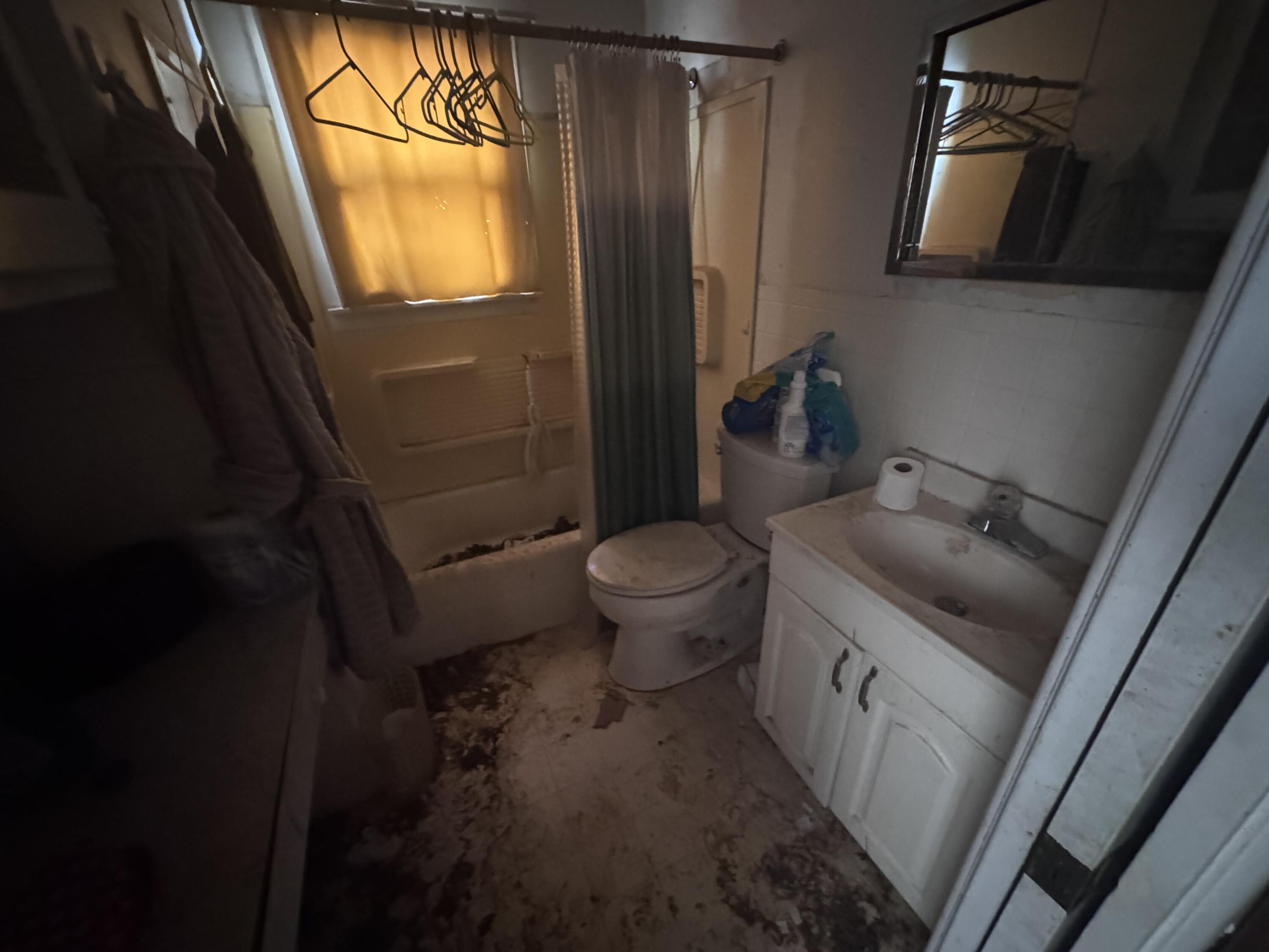 5116 44th Street Lubbock, TX 79414 - Photo 9 of 14 a bathroom with a toilet sink and mirror