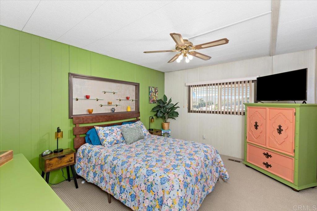 28890 Lilac Road, Unit 80 Valley Center, CA 92082 - Photo 13 of 33 a bedroom with a bed and a flat screen tv